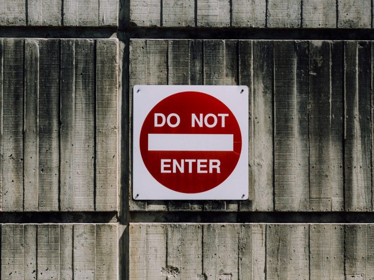 Image of a metal wall with a 'Do not enter' sign on it