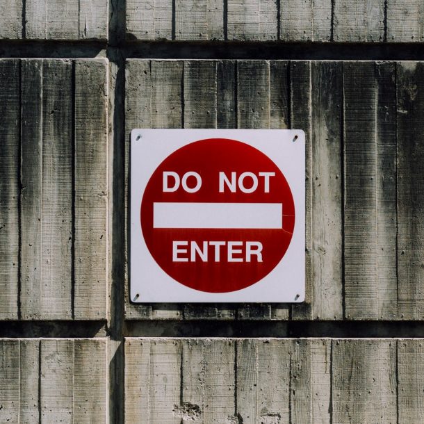 Image of a metal wall with a 'Do not enter' sign on it